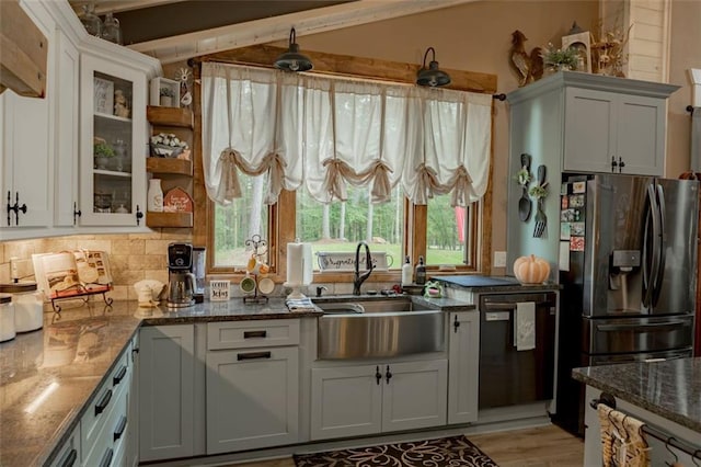 kitchen featuring sink, white cabinets, vaulted ceiling with beams, and dishwasher