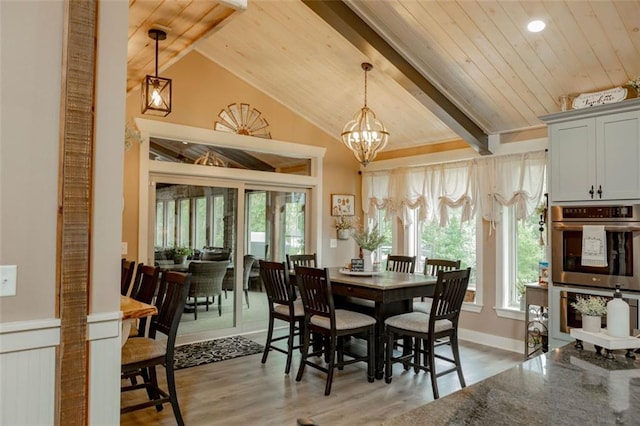 dining area with a chandelier, vaulted ceiling, hardwood / wood-style flooring, and wooden ceiling