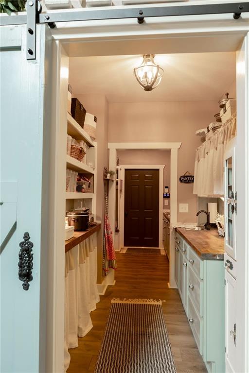 mudroom featuring sink and dark hardwood / wood-style floors