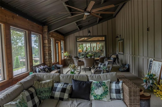 sunroom with vaulted ceiling with beams, wooden ceiling, and ceiling fan