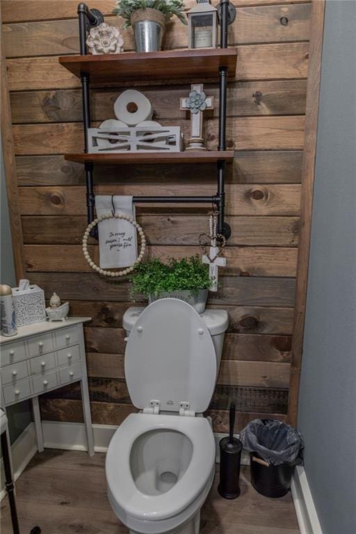 bathroom featuring toilet and wood-type flooring