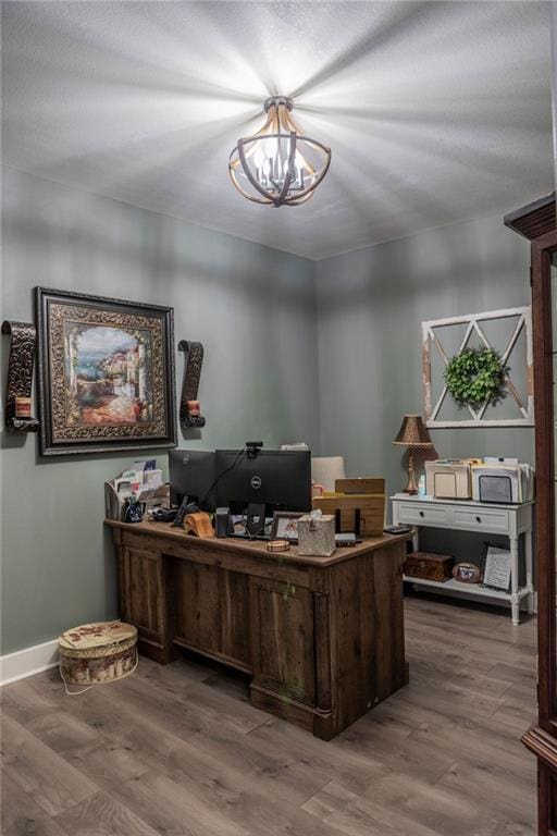 office with a notable chandelier and hardwood / wood-style flooring