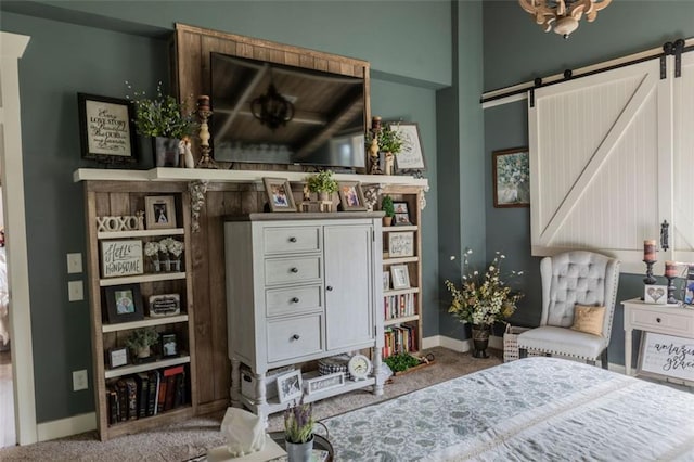 carpeted bedroom featuring a barn door