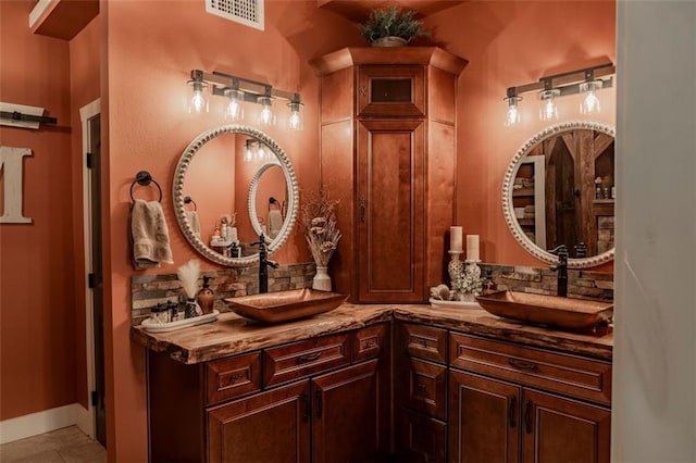 bathroom with vanity and tile patterned flooring