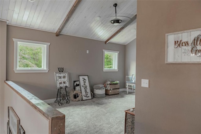 living area with vaulted ceiling with beams, carpet flooring, and wooden ceiling