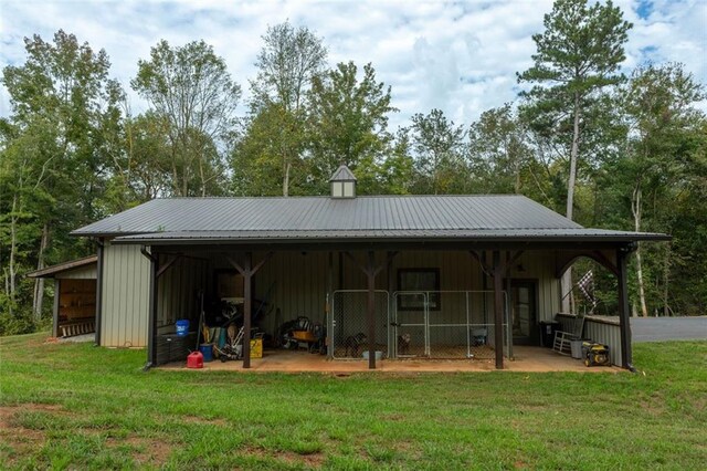 back of property featuring a lawn