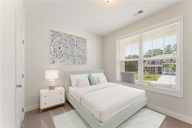 carpeted bedroom with baseboards and visible vents