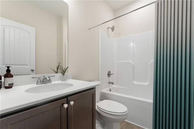 full bathroom featuring  shower combination, vanity, and toilet