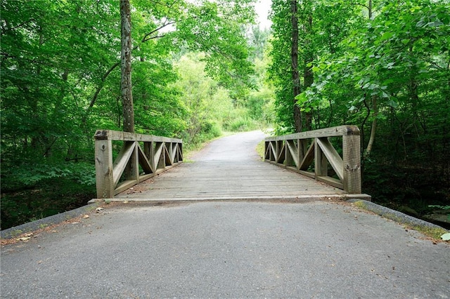 view of gate featuring a view of trees