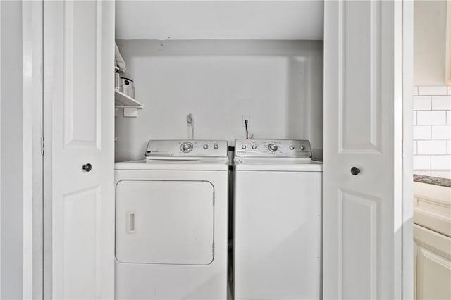 clothes washing area featuring washer and dryer and laundry area