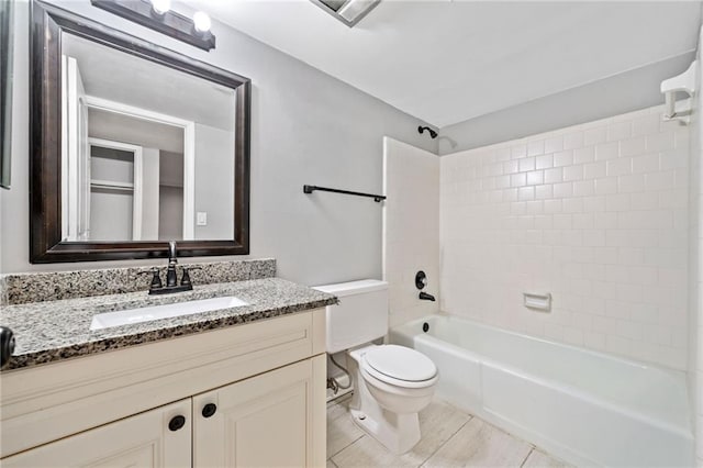 bathroom with vanity, toilet, and shower / bathtub combination