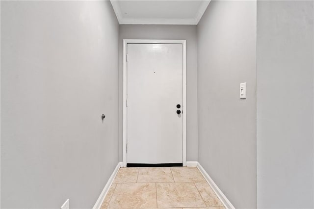 entryway with light tile patterned floors, ornamental molding, and baseboards