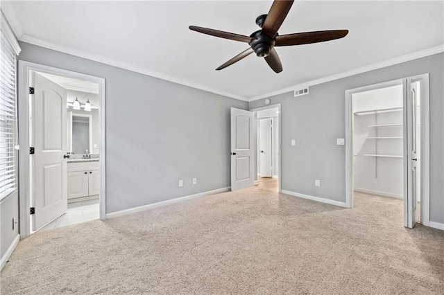 unfurnished bedroom with ornamental molding, carpet flooring, visible vents, and baseboards