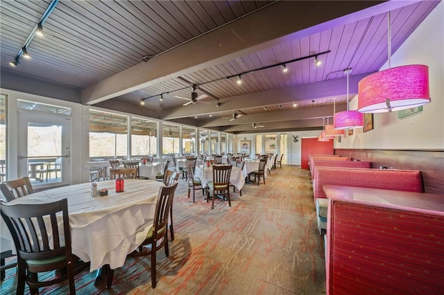 dining space featuring rail lighting