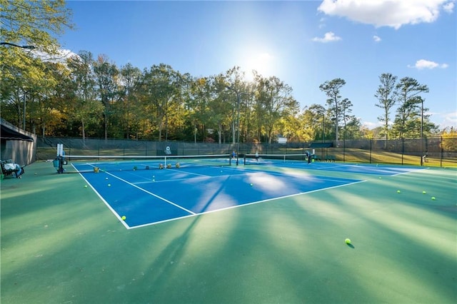 view of tennis court featuring fence