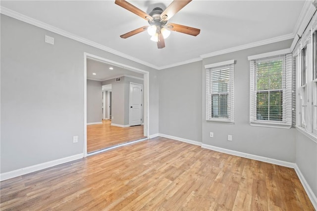 unfurnished room with light wood-style floors, ceiling fan, baseboards, and crown molding