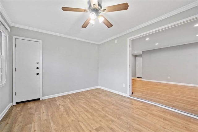 spare room featuring ceiling fan, ornamental molding, wood finished floors, and baseboards