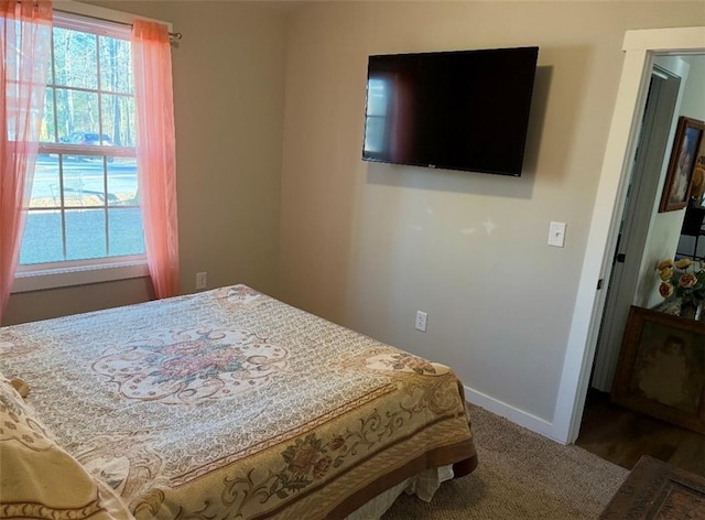 bedroom featuring carpet flooring and baseboards