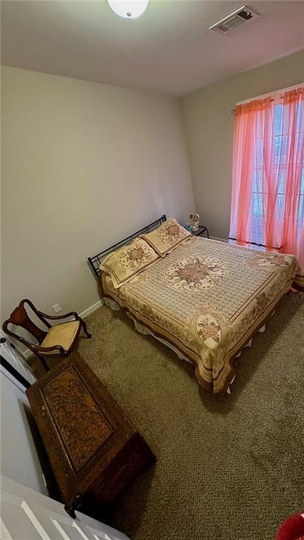 bedroom with baseboards, visible vents, and carpet flooring