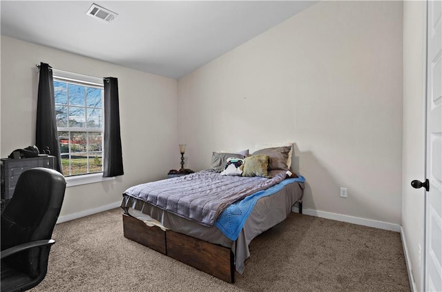 bedroom with baseboards, visible vents, and light colored carpet