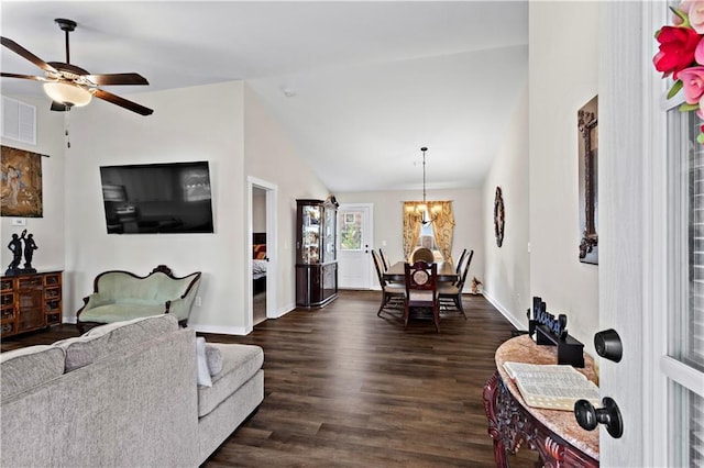 living room with baseboards, visible vents, lofted ceiling, dark wood-style floors, and ceiling fan with notable chandelier