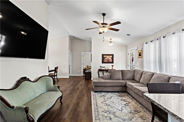 living area featuring dark wood finished floors, lofted ceiling, visible vents, ceiling fan, and baseboards