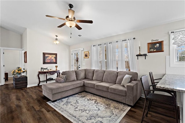 living area with lofted ceiling, ceiling fan, dark wood-style floors, and baseboards