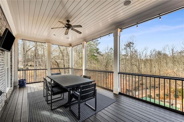 deck with outdoor dining area and ceiling fan