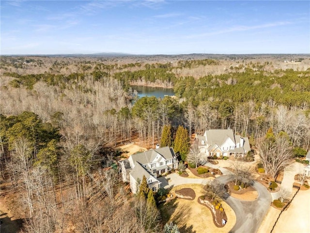 aerial view featuring a forest view and a water view