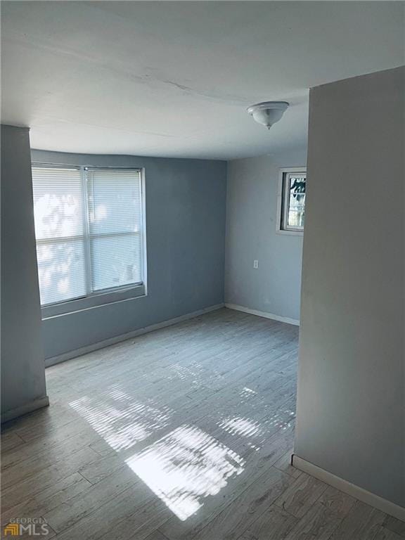 unfurnished room featuring hardwood / wood-style flooring