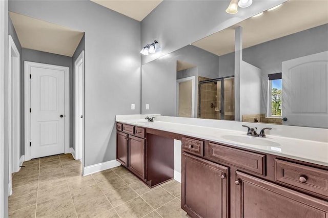 bathroom featuring a sink, tile patterned flooring, double vanity, and a stall shower
