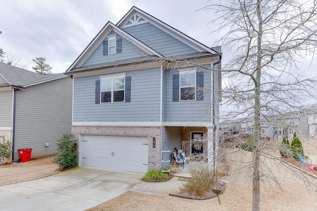 view of front facade featuring a garage, concrete driveway, and brick siding