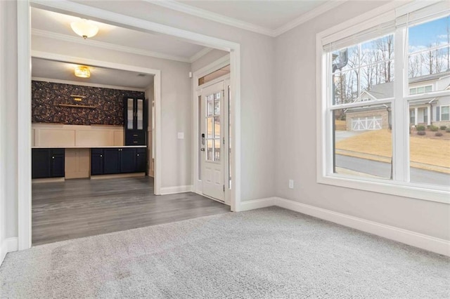 interior space with crown molding and dark carpet