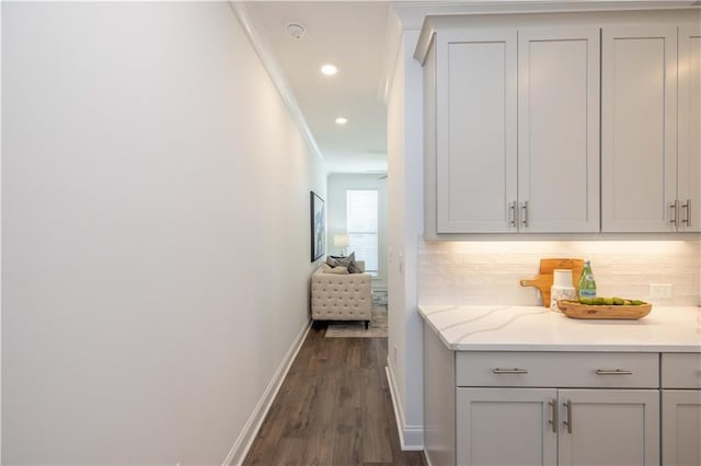 hallway featuring baseboards, dark wood-type flooring, recessed lighting, and ornamental molding