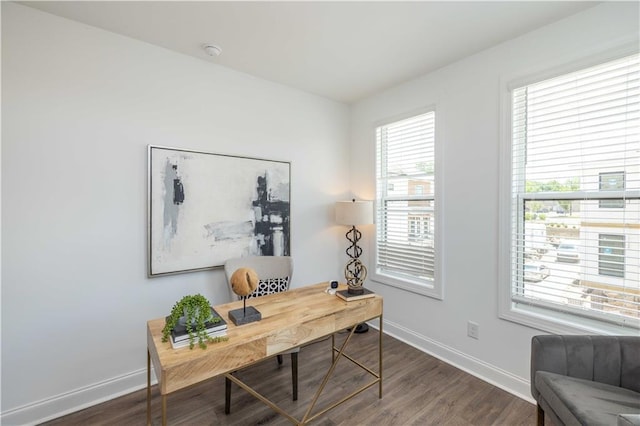home office featuring baseboards and wood finished floors