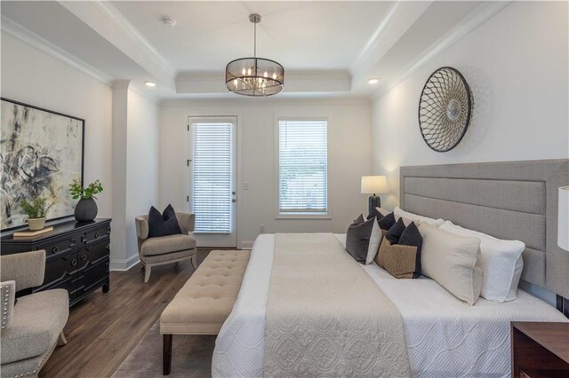 bedroom with dark wood-style flooring, crown molding, a chandelier, access to outside, and a raised ceiling