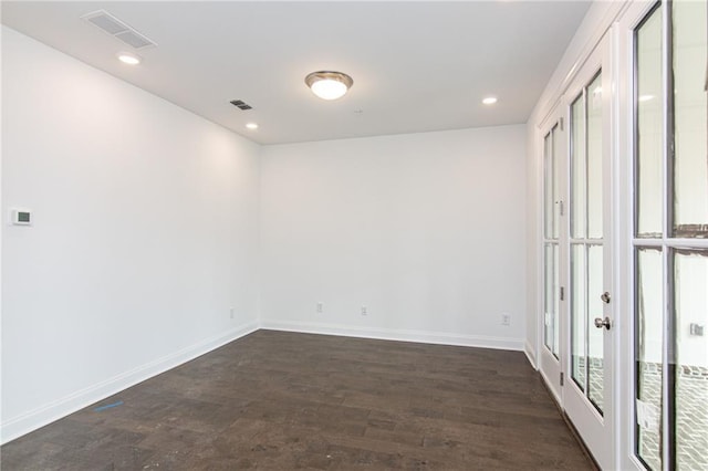 unfurnished room with dark wood-style flooring, baseboards, recessed lighting, and french doors