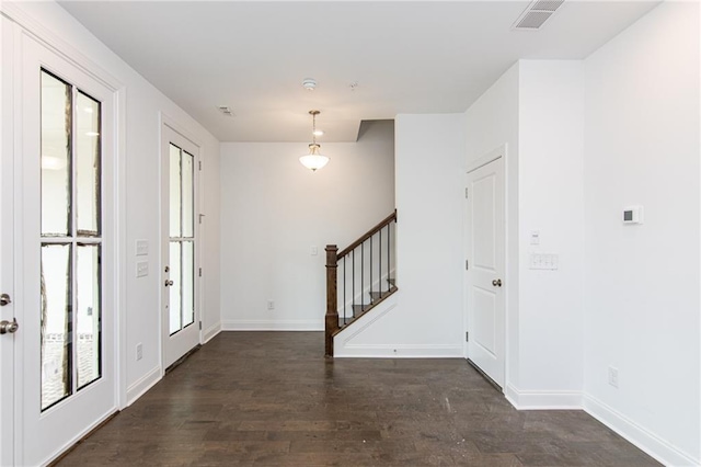 foyer featuring stairway, dark wood-style floors, and baseboards