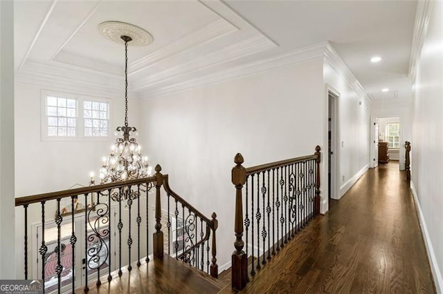 2616 Boddie Pl, Duluth, GA 30097 - hall featuring wood finished floors, baseboards, an upstairs landing, an inviting chandelier, and ornamental molding
