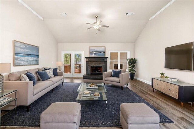 8230 Dawson View Way, Cumming, GA 30028 - living area featuring a ceiling fan, vaulted ceiling, a brick fireplace, wood finished floors, and baseboards