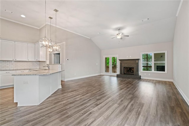 8230 Dawson View Way, Cumming, GA 30028 - unfurnished living room featuring baseboards, ceiling fan with notable chandelier, and wood finished floors