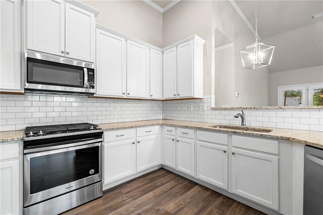 8230 Dawson View Way, Cumming, GA 30028 - kitchen featuring appliances with stainless steel finishes, a sink, a chandelier, white cabinetry, and decorative backsplash