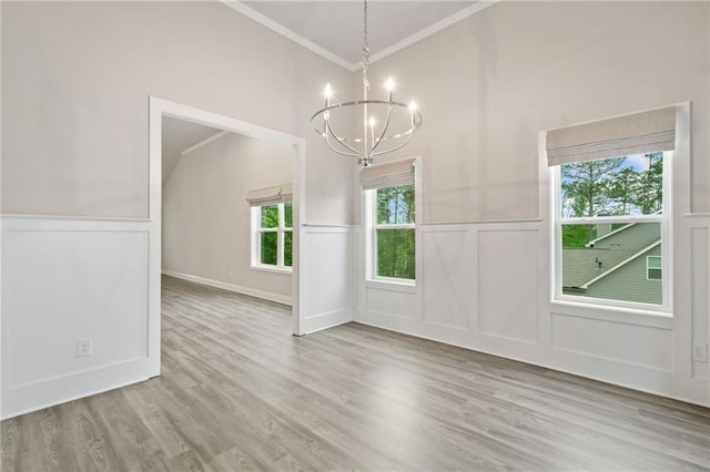 8230 Dawson View Way, Cumming, GA 30028 - unfurnished dining area featuring crown molding, a notable chandelier, wood finished floors, and a decorative wall