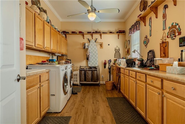 laundry room with light hardwood / wood-style floors, cabinets, crown molding, and independent washer and dryer