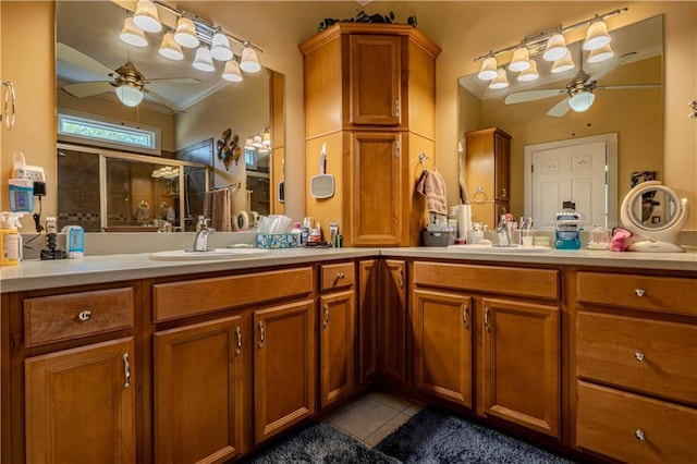 bathroom featuring tile patterned floors, walk in shower, crown molding, and vanity