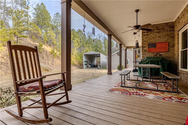 wooden deck featuring ceiling fan and area for grilling