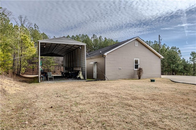 view of property exterior featuring a yard and a carport