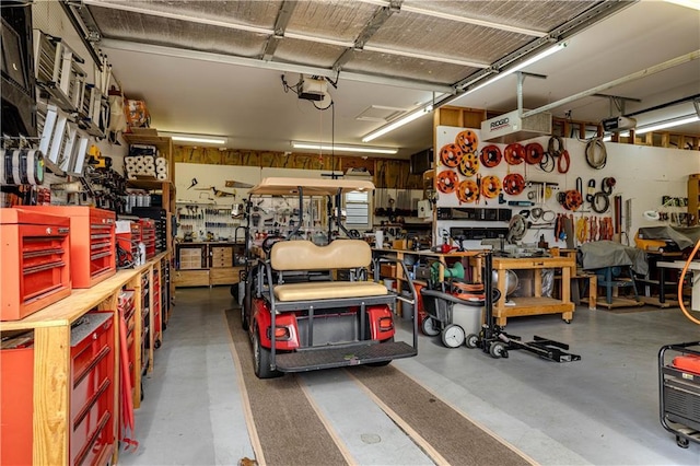 garage featuring a garage door opener and a workshop area