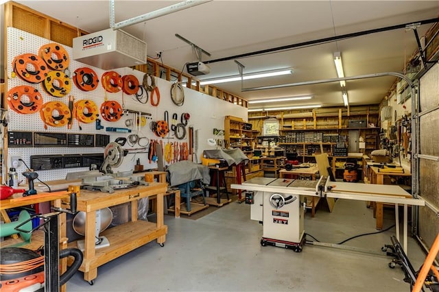 garage featuring a garage door opener and a workshop area