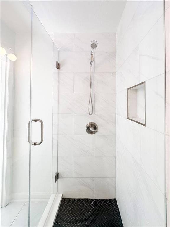 bathroom with walk in shower and tile patterned floors